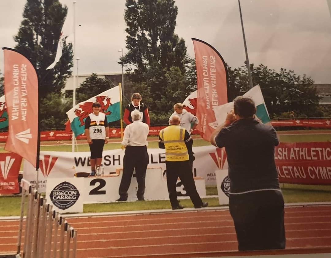 Sabrina accepting a gold medal at one of her very first competitions