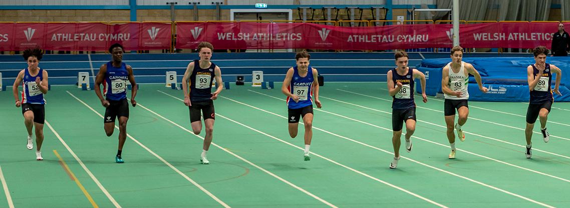 Junior boys athletes competing in the 60m sprint indoors.