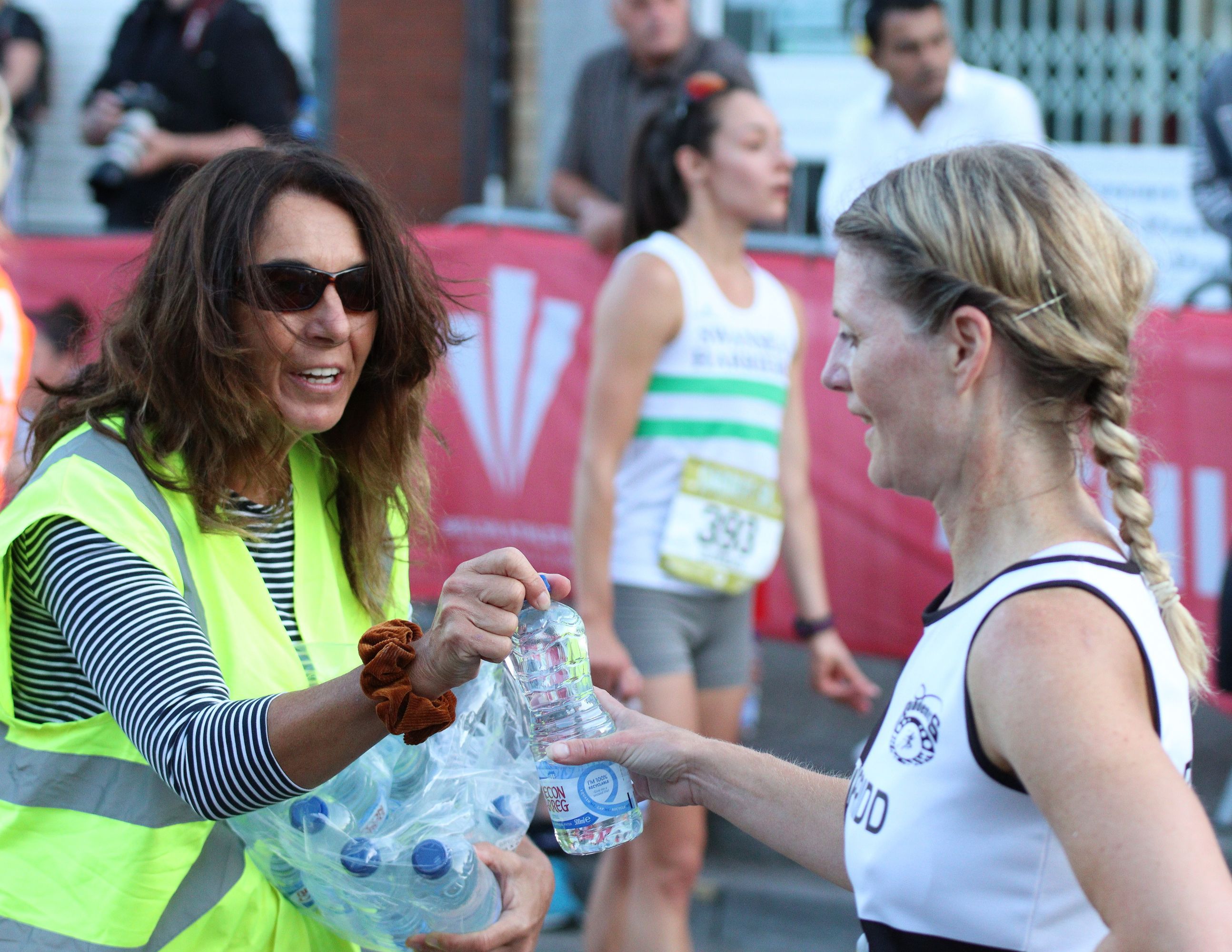 Volunteers handing out water after the race ..jpg